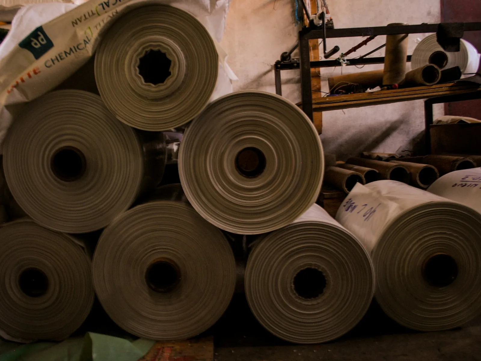 Reels of kraft paper stacked on end in a box plant store
