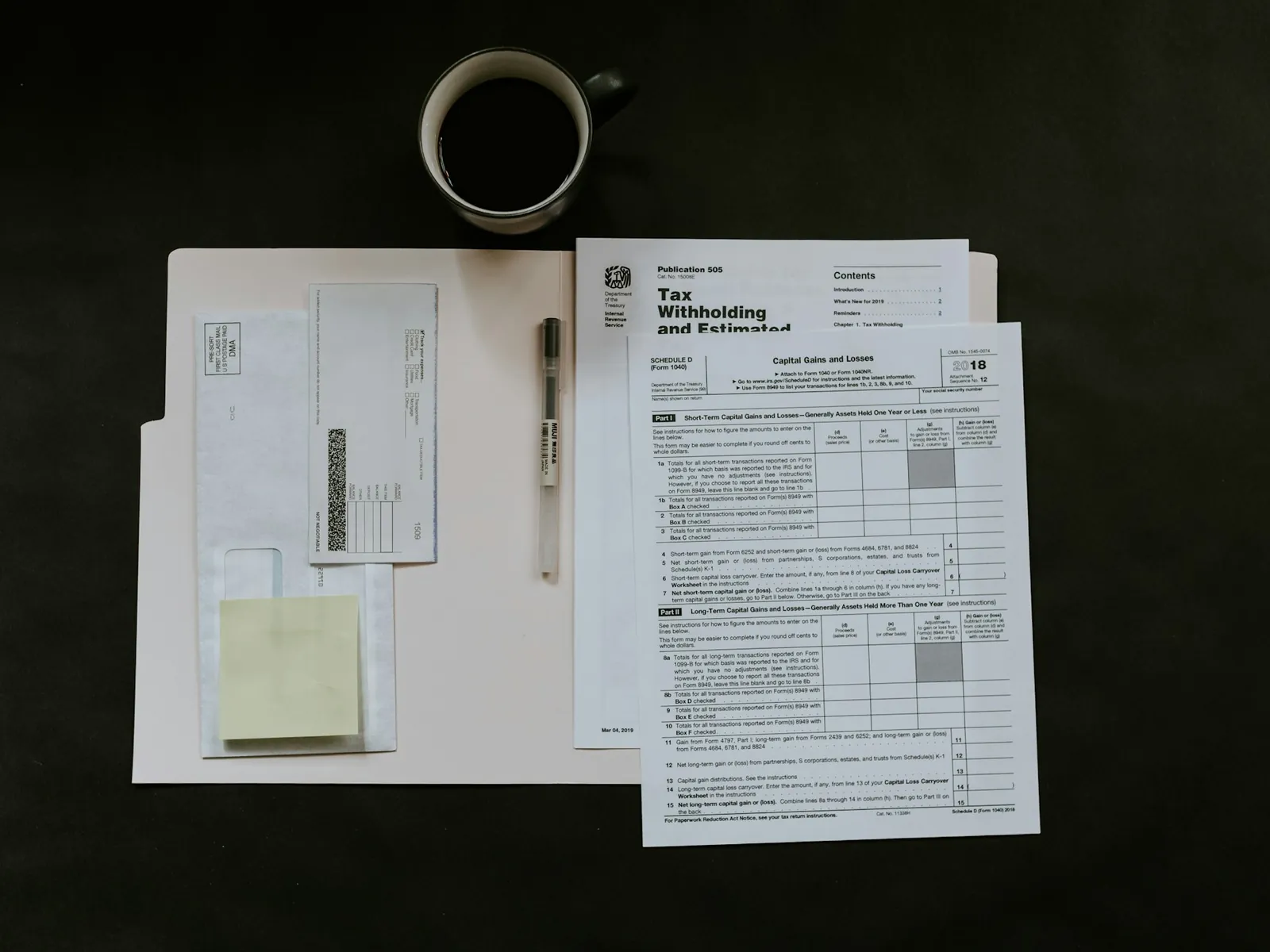Sales-tax return forms and a pen laid out on a desk